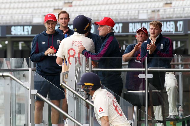 England’s Ollie Pope is congratulated by captain Joe Root