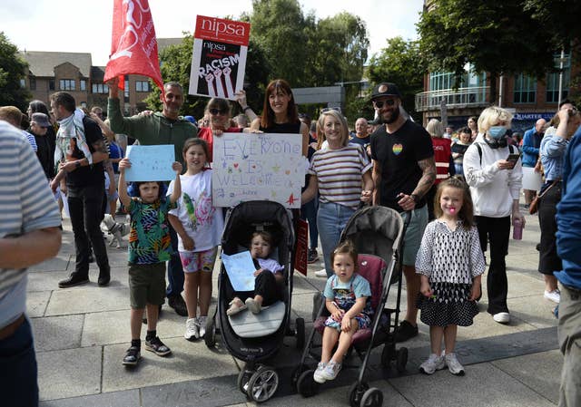 Demonstrators take part in a United Against Racism rally in Belfast