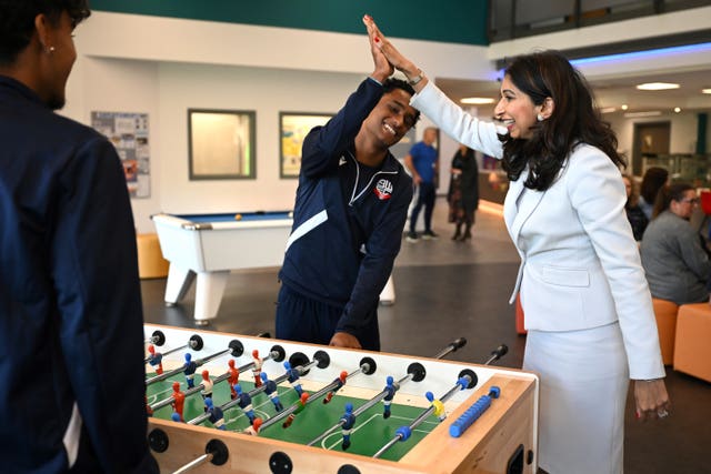 Home Secretary Suella Braverman plays a game of table football during a visit to Bolton Lads and Girls Club in Bolton, Greater Manchester 