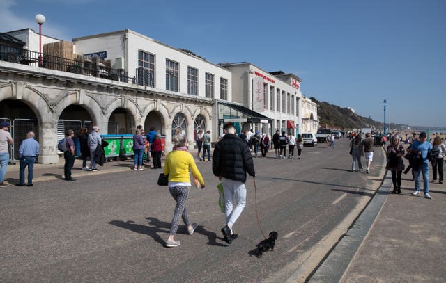 People walk along the sea front in Bournemouth