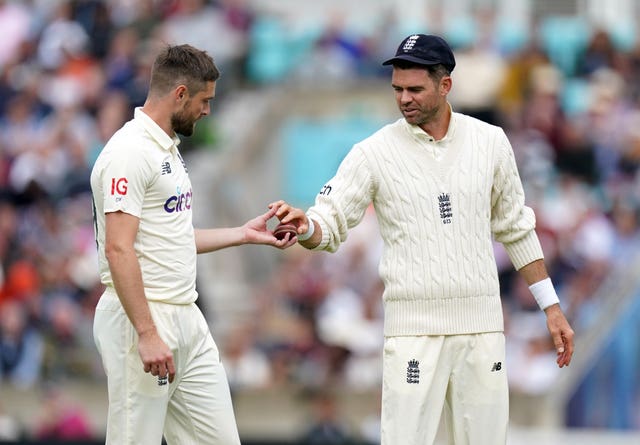 James Anderson hands the ball to Chris Woakes during an England Test match (Adam Davy/PA)