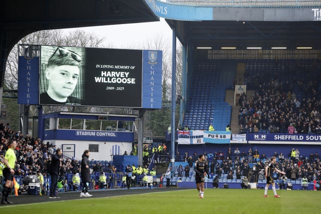Tribute to Harvey Willgoose shown on a big screen during a football match