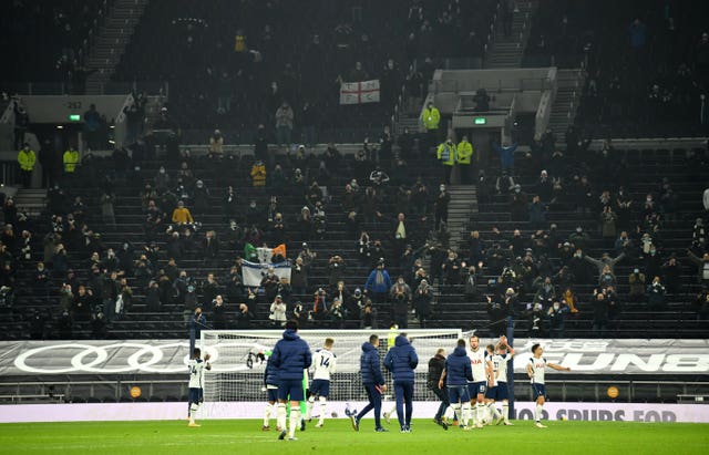 Tottenham players applaud the 2,000 fans who were in the stadium to watch their victory 