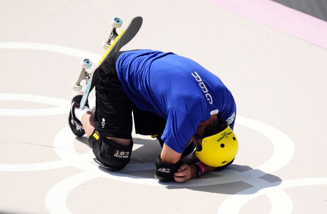 Andy Macdonald is brought to his knees during the qualifying heats of the men's park skateboarding competition at the Paris Olympics