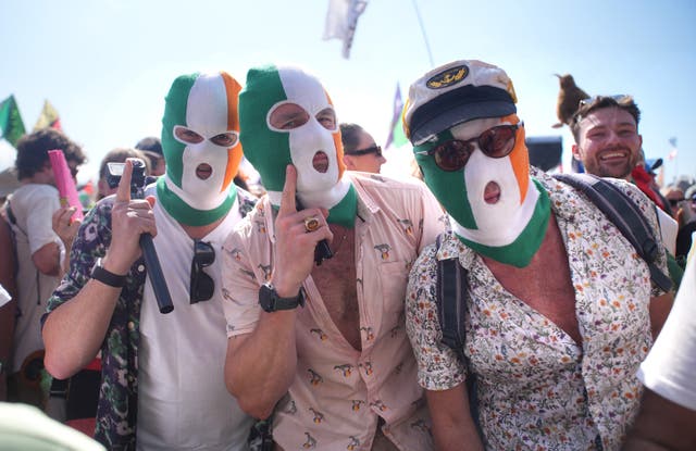 Kneecap fans wear distinctive Irish flag balaclavas in the audience 