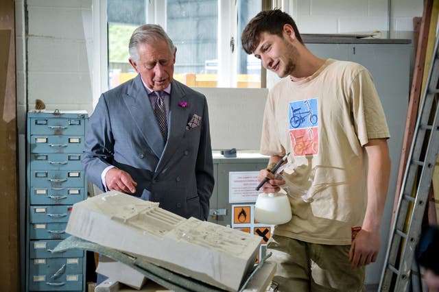 The Prince of Wales - speaking to student stonemason Archie Stoke-Faiers during a previous visit to Poundbury, Dorset - fears the skill is dying out (PA Wire / Ben Birchall)