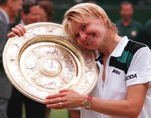 Jana Novotna hugs the Wimbledon trophy