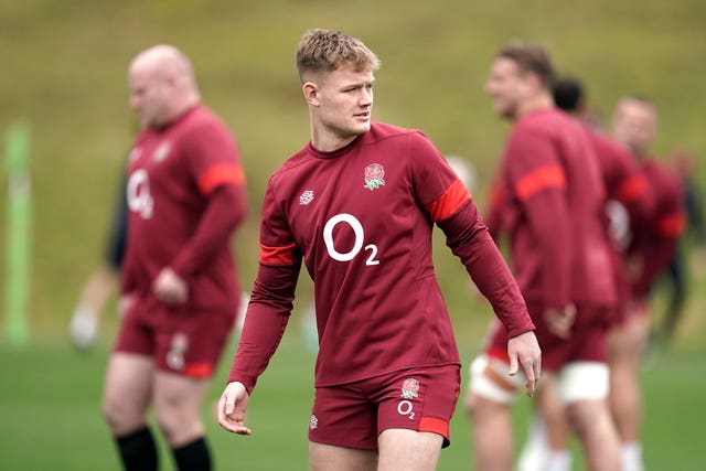 Fin Smith looks over his shoulder during an England training session