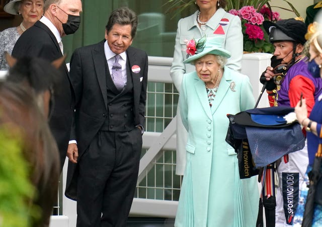 Queen Elizabeth II with racing manager John Warren, second left, and jockey Frankie Dettori, right, inspect horse Reach For The Moon at Royal Ascot