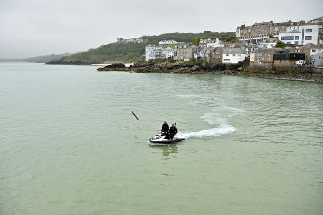 Police officers on a jet ski patrol the bay in St Ives during the G7 summit in Cornwall 