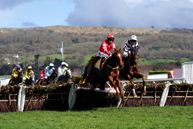 Blood Destiny ridden by jockey Patrick Mullins (second right, red silks) in action as they compete in the JCB Triumph Hurdle at the Cheltenham Festival 