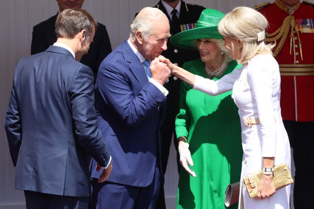 The King kissed the hand of Brigitte Macron as he and the Queen welcome the Macrons to Windsor in 2025 