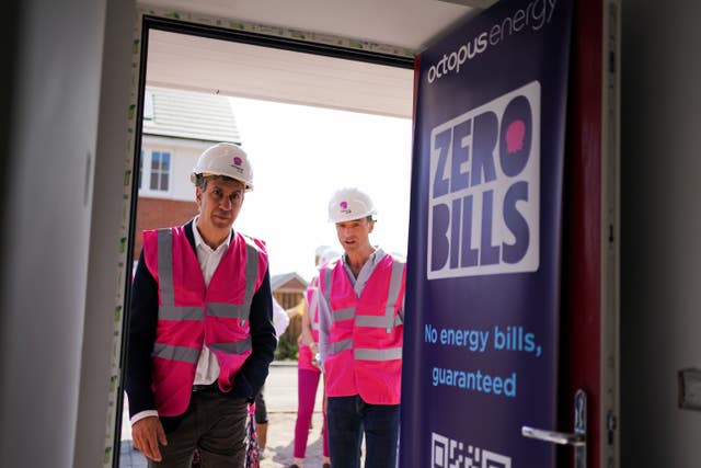 Ed Miliband and another man at doorway of a new-build zero bills home in Staffordshire
