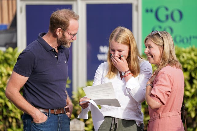 A student reacts when reading their A-level results at Norwich School