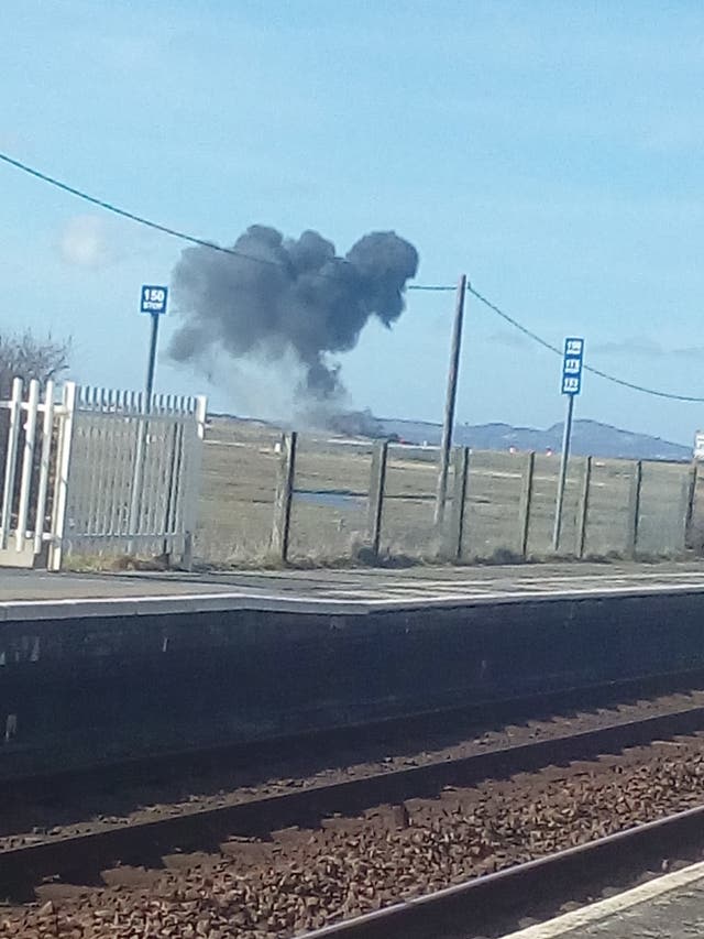 A plume of smoke rises from the crashed jet (Sian Rebecca Williams/PA)