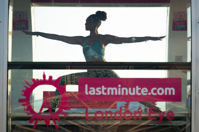 Woman performs stretches behind a Lastminute.com sign