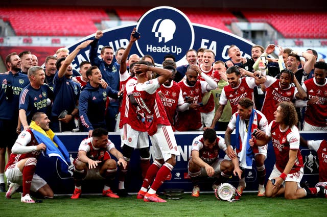 Pierre-Emerick Aubameyang, centre, left, dropped the FA Cup trophy (Adam Davy/PA)