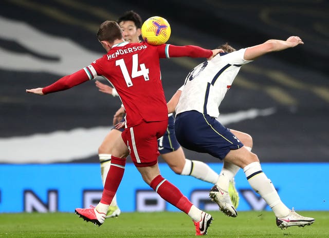 Liverpool captain Jordan Henderson tackles Tottenham striker Harry Kane