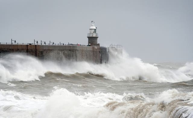 Waves crash against the harbour wall during wet and windy weather in Folkestone