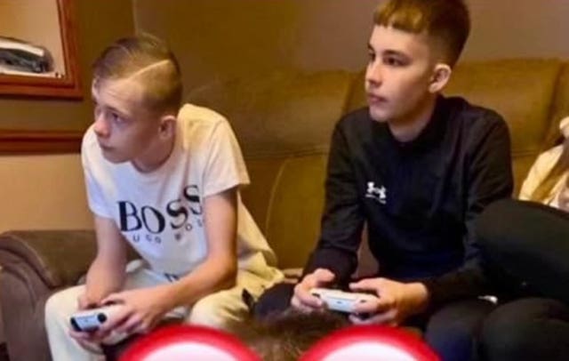 Mason Rist and Max Dixon holding consoles 