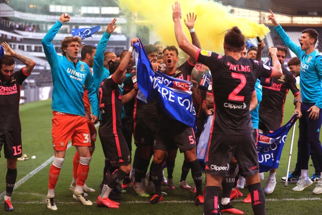 Leeds' players and staff celebrate after victory a Derby