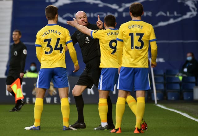 Referee Lee Mason was confronted by some Brighton players