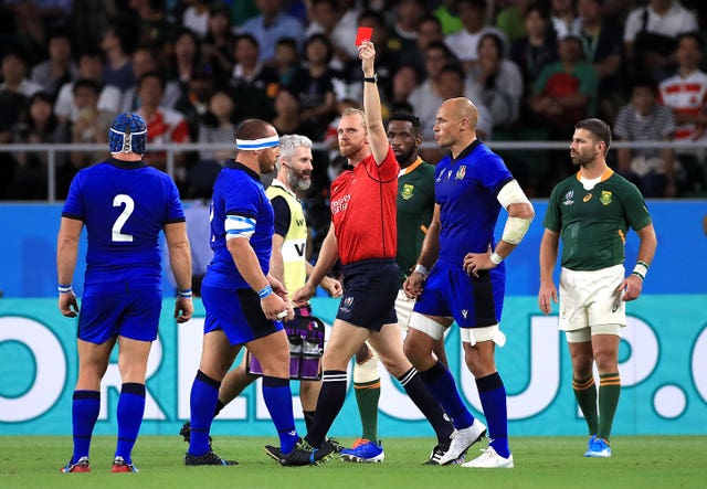 Referee Wayne Barnes, centre, shows a red card to Italy's Andrea Lovotti, second left