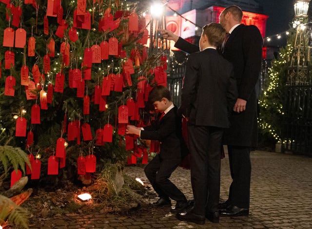 Prince Louis and his siblings tie red notes to a 'kindness tree' 