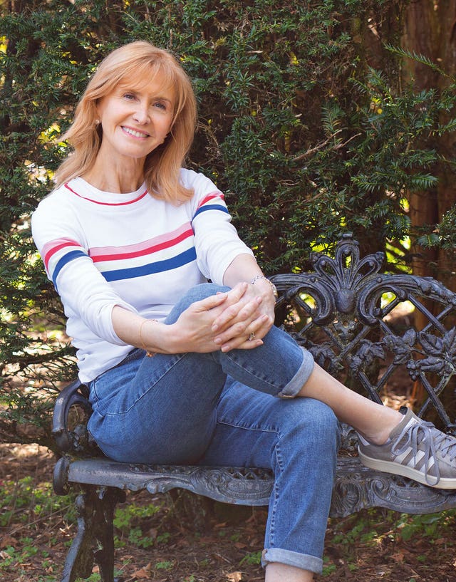 Jackie Bird sits on a bench outside