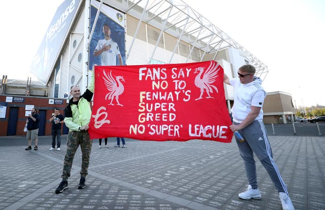 Fans hold up an anti-FSG banner