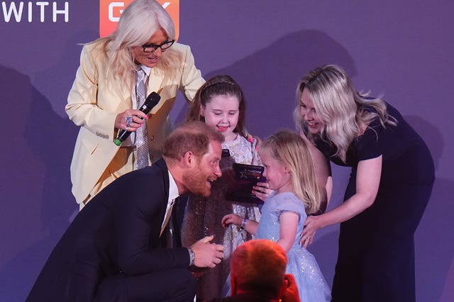 The Duke of Sussex hugs Margot Jones-Billington's sister Adelaide during the WellChild Awards 2026