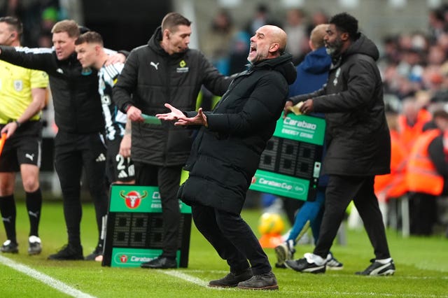 Manchester City manager Pep Guardiola (centre) reacts 