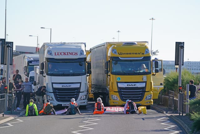 Protesters lie in front of lorries