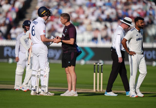 Zak Crawley has his finger checked by England’s physio in the final over