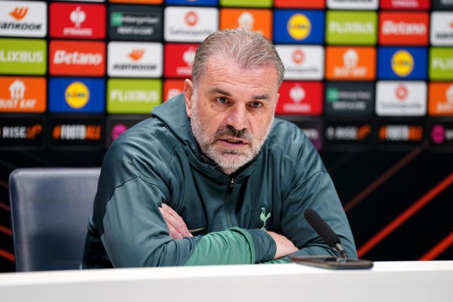 Ange Postecoglou crosses his arms during a press conference