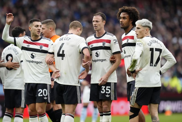 Manchester United players form a wall against a free-kick