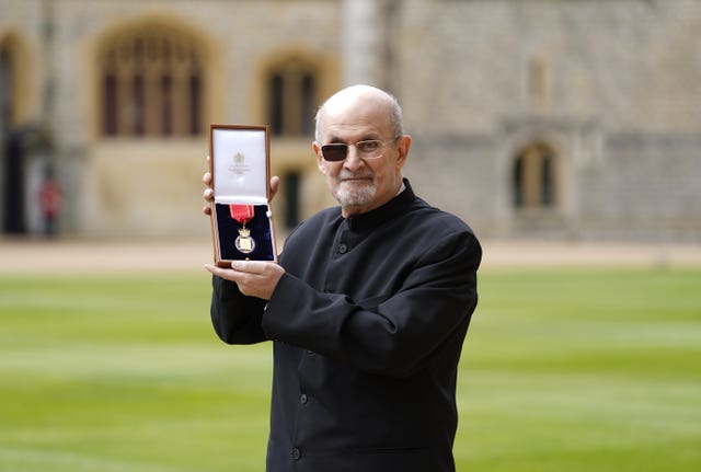 Sir Salman Rushdie at Windsor Castle in a black suit