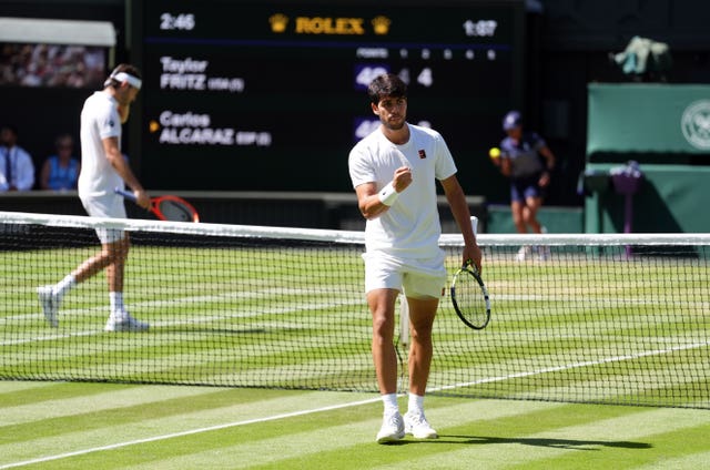 Carlos Alcaraz pumps his fist in celebration at winning a point