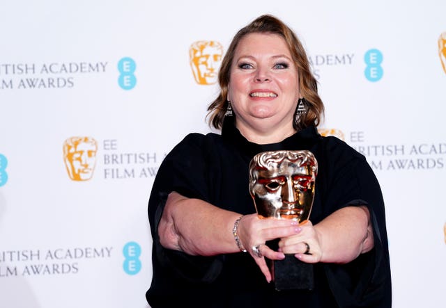 Joanna Scanlan smiling while holding a Bafta award