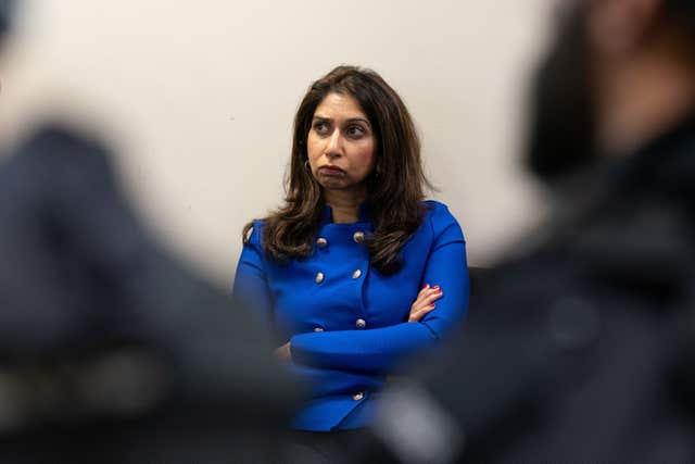 Home Secretary Suella Braverman standing with arms folded