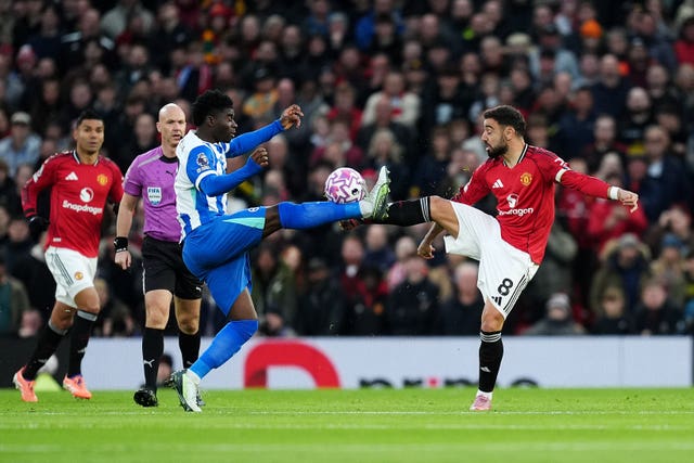 Manchester United’s Bruno Fernandes (right) and Brighton and Hove Albion’s Carlos Baleba battle for the ball