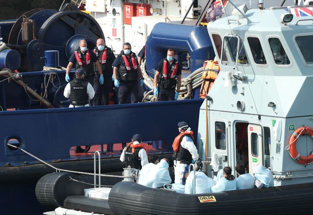 A Border Force vessel brings a group of people thought to be migrants into Dover, Kent