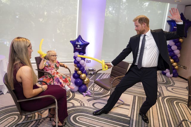 The Duke of Sussex play fights using balloon swords at the WellChild Awards