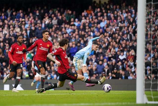 Phil Foden scores Manchester City's second of the derby