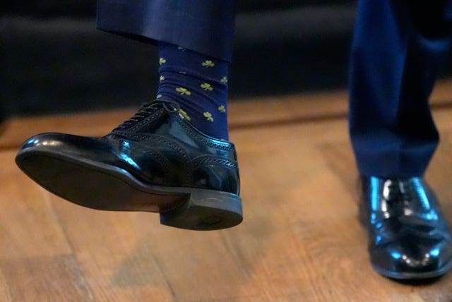 US vice president JD Vance showing off a pair of Shamrock-adorned socks
