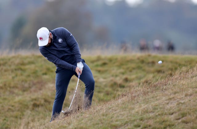 Tyrrell Hatton plays from a steep slope