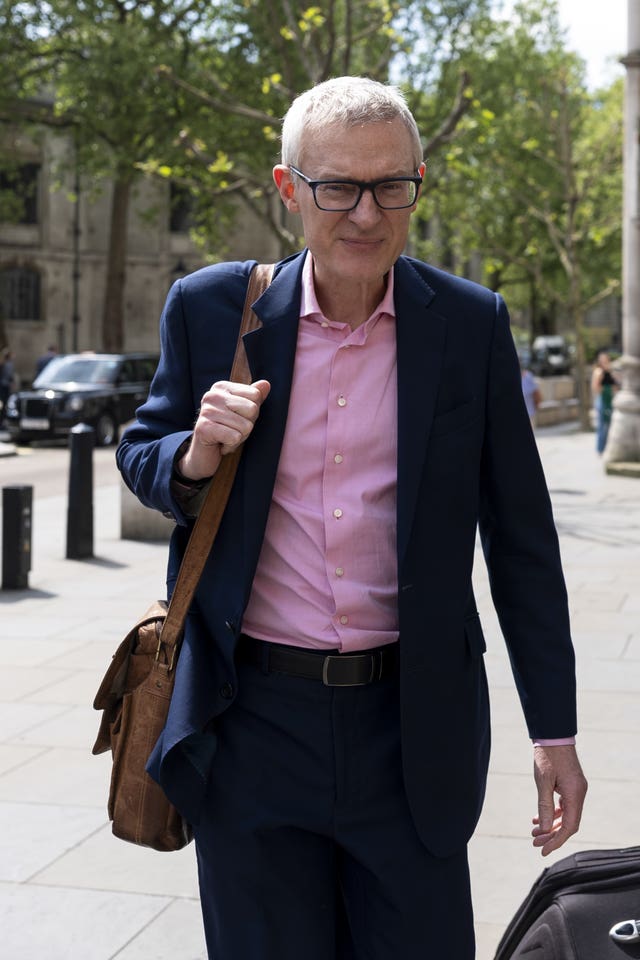 Jeremy Vine dressed in suit with bag over his shoulder