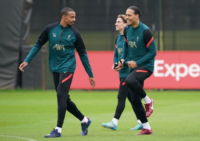 Joel Matip (left), Kostas Tsimikas and Virgil Van Dijk (right) during training