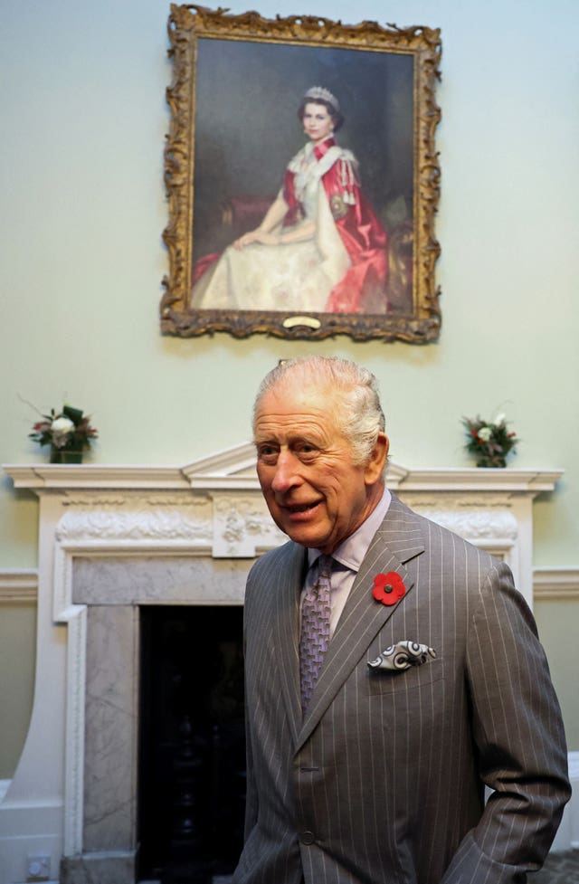 Charles with a painting of the Queen, his mother, behind him at Mansion House