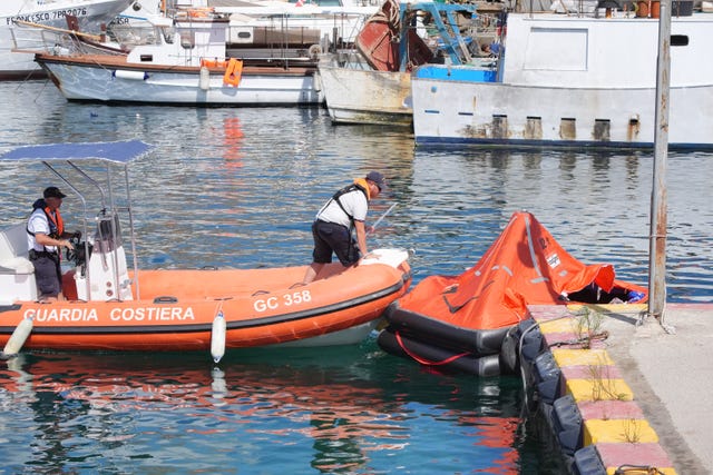 The coastguard handle a rapid inflatable emergency lifeboat in Porticello Harbour on the Sicilian coast where the search continues for Mike Lynch and his daughter Hannah